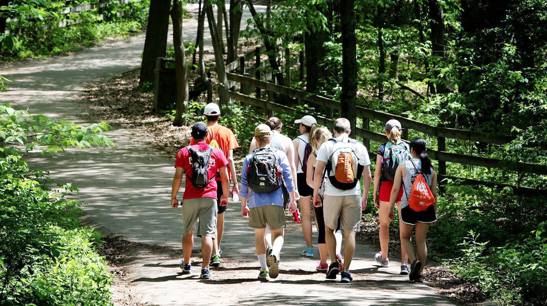 A group of people walking on the trail